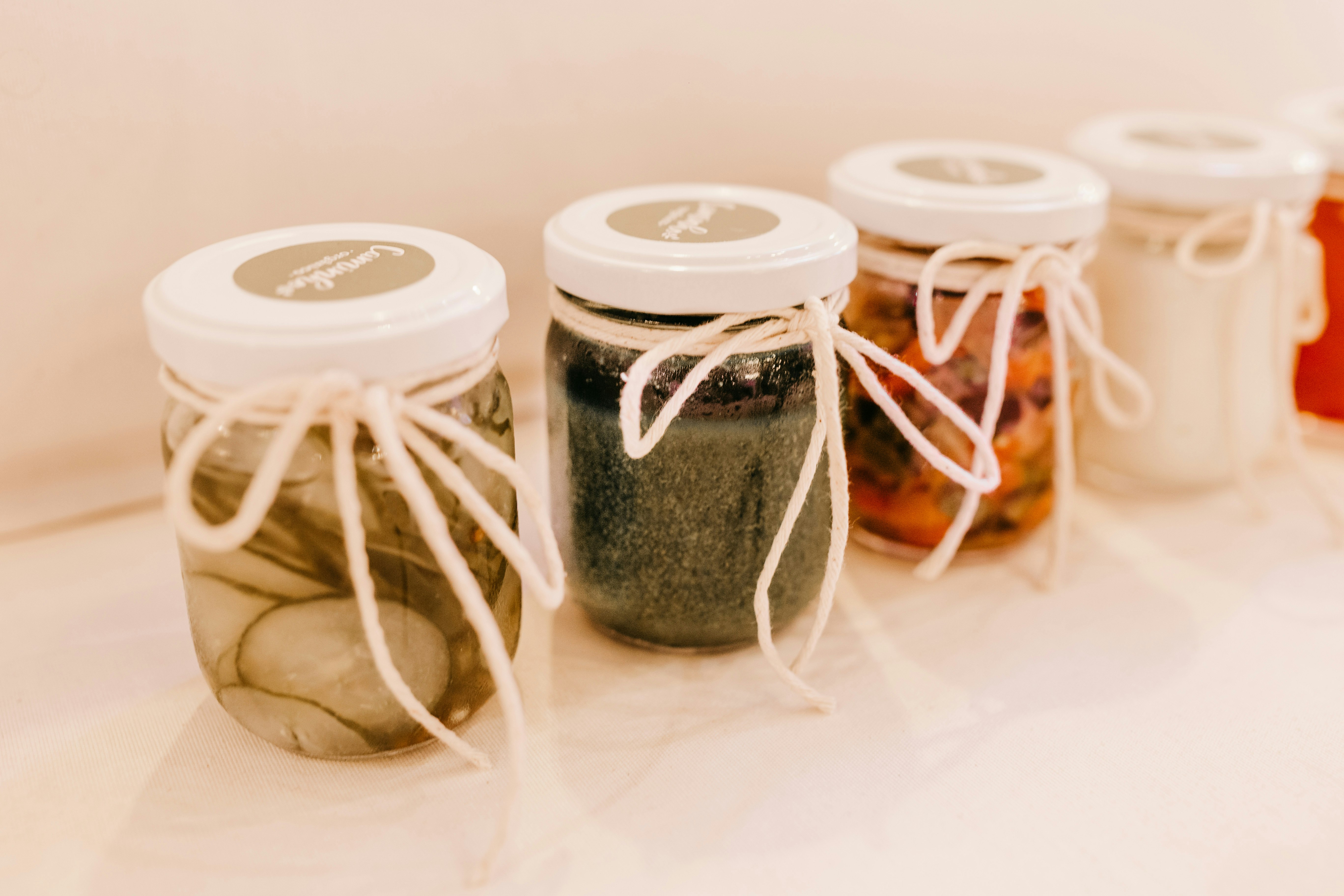 two white and clear glass jars